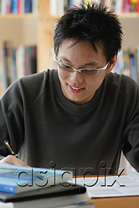 AsiaPix - A young man studies in the library