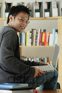 AsiaPix - A young man studies in the library
