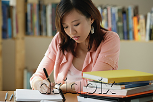 AsiaPix - A young woman studies in the library