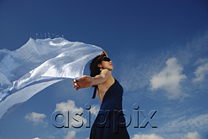 AsiaPix - A young woman dances in the wind with a veil
