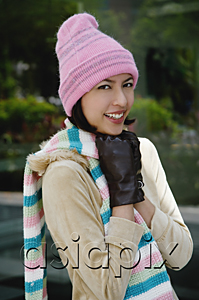 AsiaPix - A woman tries to keep warm in a hat and gloves as she smiles at the camera