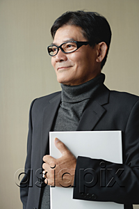 AsiaPix - A man with glasses holding a white folder