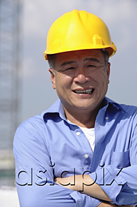 AsiaPix - A man with a yellow helmet smiles at the camera