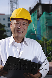 AsiaPix - A man with a yellow helmet smiles at the camera, holding file