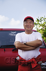 AsiaPix - A man with a red van smiles at the camera as he works