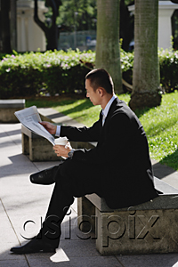 AsiaPix - A man sits and reads the newspaper in the park