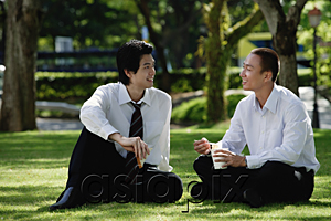 AsiaPix - Two men eat their lunch together in the park