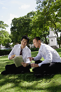 AsiaPix - Two men read the newspaper in the park