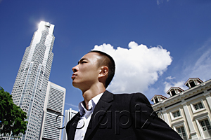 AsiaPix - A man in a suit with a skyscraper behind him
