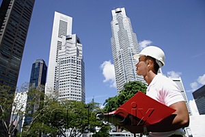 AsiaPix - A man with a helmet stands in front of skyscrapers