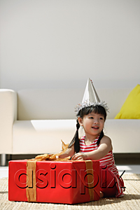 AsiaPix - A young girl unwraps a birthday present