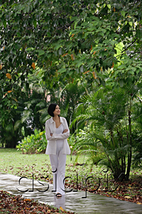 AsiaPix - A woman strolls down a path in a garden