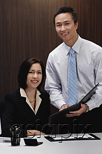 AsiaPix - A man and a woman smile at the camera while they are at work