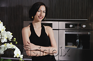 AsiaPix - A woman smiles at the camera in the kitchen
