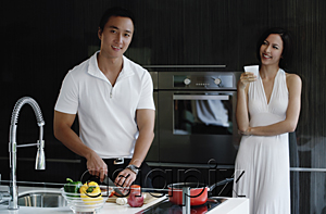 AsiaPix - A couple prepare dinner together in the kitchen