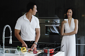 AsiaPix - A couple prepare dinner together in the kitchen