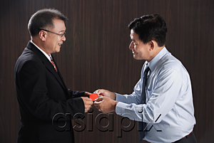 AsiaPix - One man gives another a business card