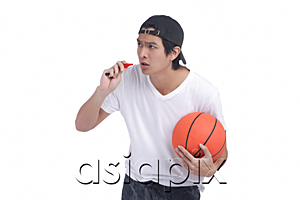 AsiaPix - A man holds a basketball