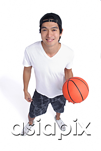 AsiaPix - A man holds a basketball and smiles at the camera