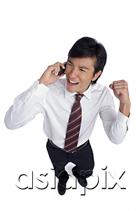 AsiaPix - A man is excited as he talks on his cellphone
