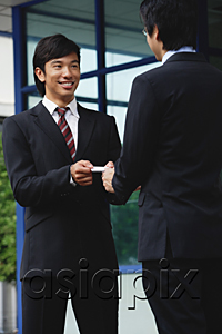AsiaPix - One man gives another his business card