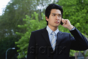 AsiaPix - A man wearing a suit talks on his cellphone