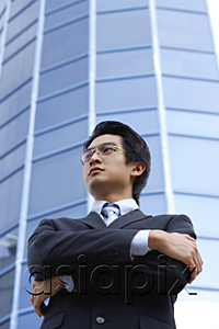 AsiaPix - A man with a suit stands in front of a skyscraper