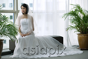AsiaPix - A bride with a white wedding gown sits down