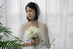 AsiaPix - A bride holds a bouquet of flowers
