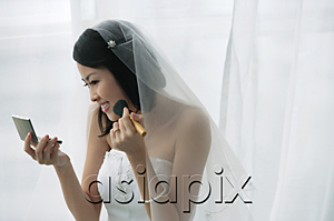 AsiaPix - A bride does her makeup in the mirror