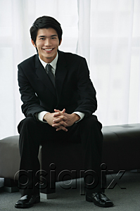 AsiaPix - A groom wearing a suit smiles at the camera