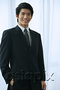AsiaPix - A groom wearing a suit smiles at the camera