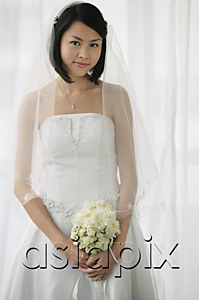 AsiaPix - A bride with a bouquet of flowers looks at the camera