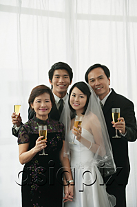 AsiaPix - A newlywed couple and their family smile at the camera together