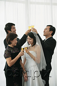 AsiaPix - A newlywed couple and their family raise their glasses for a toast