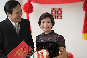 AsiaPix - A couple smile as they hold wedding gifts