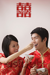 AsiaPix - A bride feeds the groom soup from a spoon