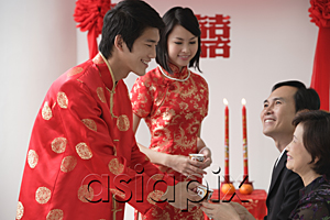 AsiaPix - A groom offers a cup of tea to another family member