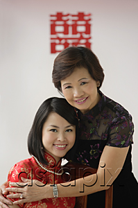 AsiaPix - A bride and her mother hug and smile at the camera