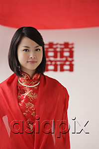 AsiaPix - A bride wearing a red silk dress looks at the camera