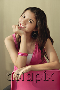 AsiaPix - A teenage girl smiles at the camera as she sits down