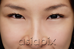 AsiaPix - A close-up of a young woman looking at the camera