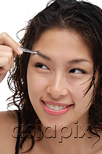 AsiaPix - A young woman shapes her eyebrows