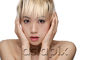 AsiaPix - A young woman looks frightened as she looks at the camera