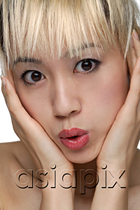 AsiaPix - A young woman with dyed blonde hair looks at the camera