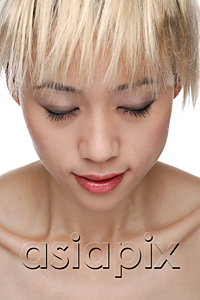 AsiaPix - A young woman with dyed blonde hair closes her eyes