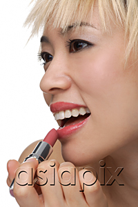AsiaPix - A young woman applies lipstick