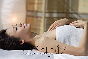 AsiaPix - A woman lying down on a massage table