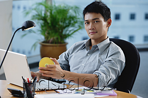 AsiaPix - A man looks at the camera as he sits at his desk