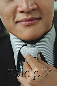 AsiaPix - A man adjusts his tie